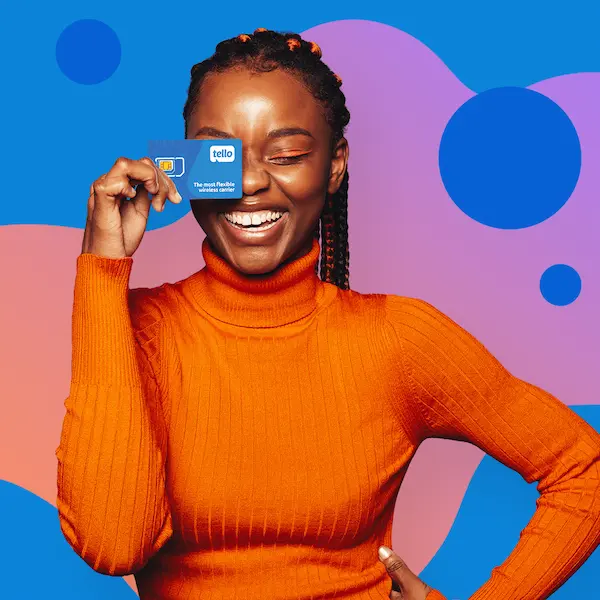 Woman in an orange turtleneck holding a Tello SIM card near her eye, winking, against a blue and purple background