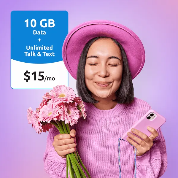 Woman in a pink hat holding pink flowers and a phone beside a "10 GB Data + Unlimited Talk & Text, $15/mo" price card